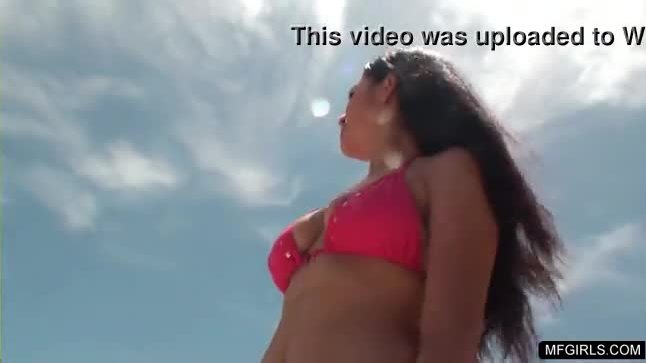 Busty latina babe flashing her tits and butt at the beach